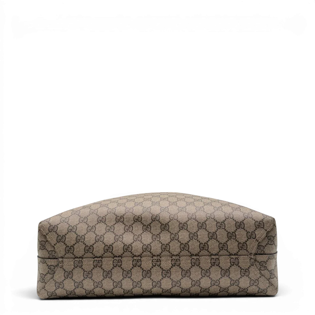 https://cdn.shopify.com/s/files/1/0564/9376/8855/files/Gucci_Shopper_Reversible_Tote_GG_Supreme_monogram_beige_5.webp?v=1781713704