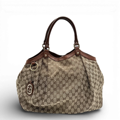 https://cdn.shopify.com/s/files/1/0564/9376/8855/files/Gucci_Shopper_Sukey_large_Lederdetails_braun_monogram_beige_vintage_GG_1046.webp?v=1770948329