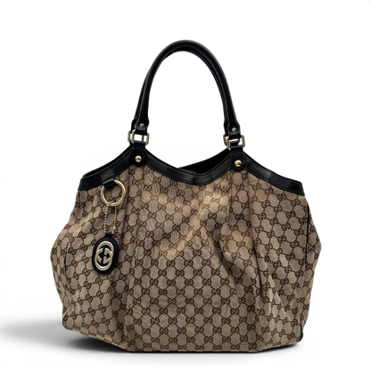https://cdn.shopify.com/s/files/1/0564/9376/8855/files/Gucci_Shopper_Sukey_large_monogram_beige_1.webp?v=1781106235