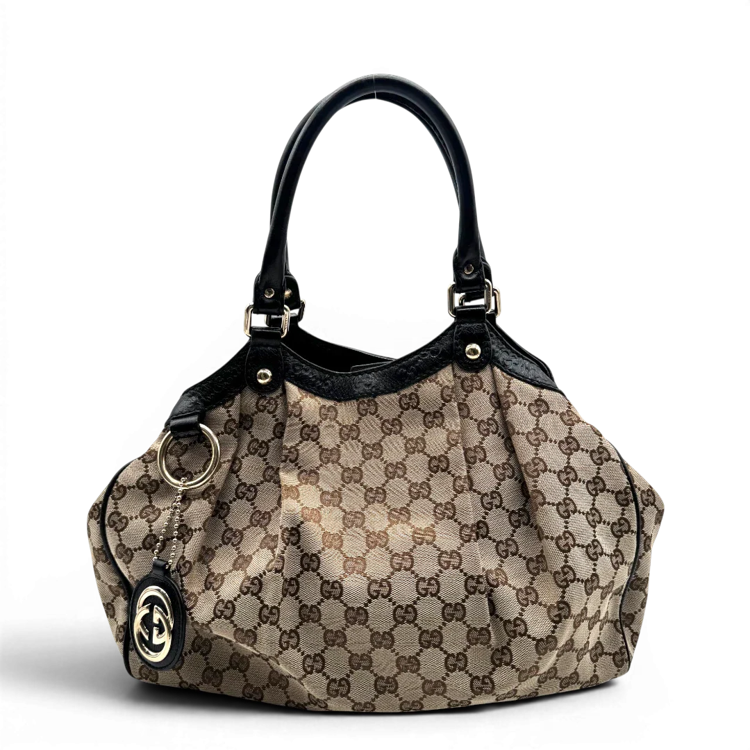 https://cdn.shopify.com/s/files/1/0564/9376/8855/files/Gucci_Shopper_Sukey_monogram_beige_vintage_GG1687.webp?v=1779407955