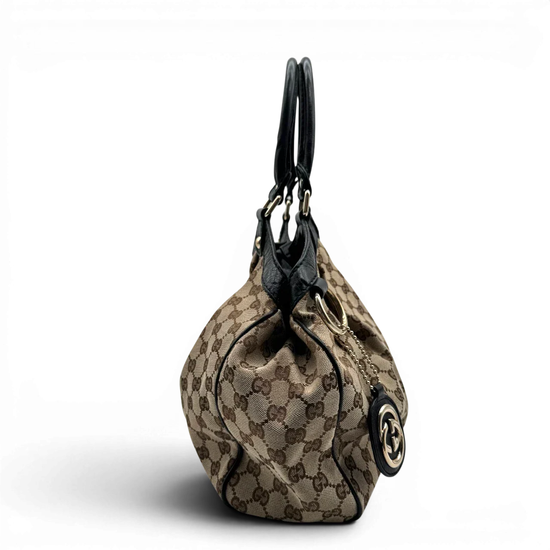 https://cdn.shopify.com/s/files/1/0564/9376/8855/files/Gucci_Shopper_Sukey_monogram_beige_vintage_GG1688.webp?v=1779407955
