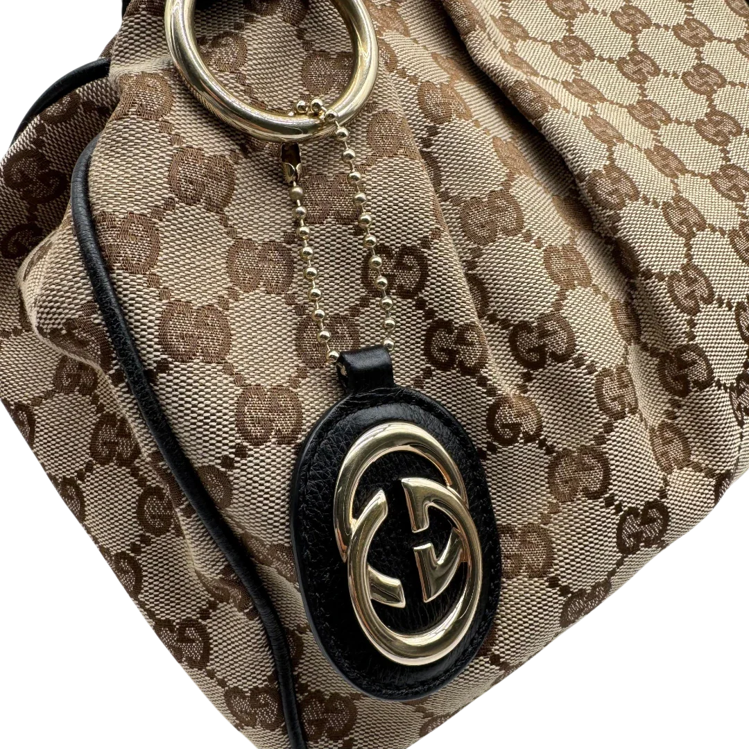 https://cdn.shopify.com/s/files/1/0564/9376/8855/files/Gucci_Shopper_Sukey_monogram_beige_vintage_GG1698.webp?v=1779407956