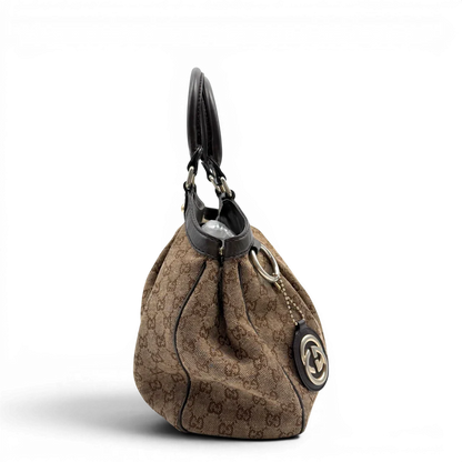 https://cdn.shopify.com/s/files/1/0564/9376/8855/files/Gucci_Shopper_Sukey_monogram_beige_vintage_GG6476.webp?v=1778675337