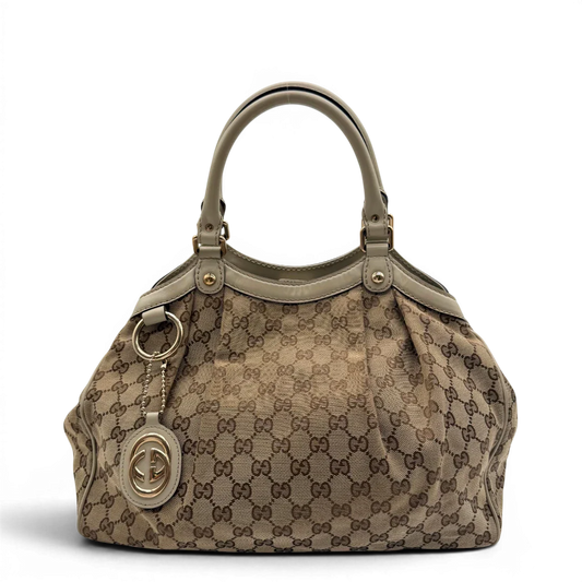 https://cdn.shopify.com/s/files/1/0564/9376/8855/files/Gucci_Shopper_Sukey_monogram_beige_vintage_GG8432.webp?v=1781108879