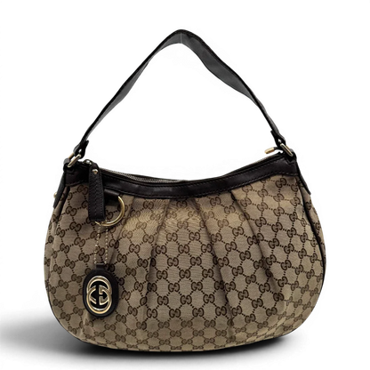 https://cdn.shopify.com/s/files/1/0564/9376/8855/files/Gucci_Umhangetasche_Sukey_One_monogram_beige_vintage_GG2127.webp?v=1779963479
