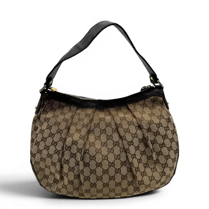 https://cdn.shopify.com/s/files/1/0564/9376/8855/files/Gucci_Umhangetasche_Sukey_One_monogram_beige_vintage_GG2130.webp?v=1779963479
