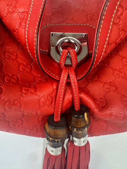 https://cdn.shopify.com/s/files/1/0900/2729/5066/files/Gucci_indy_bag_red_monogram_2007_Chrome_Detail.jpg?v=1776362149