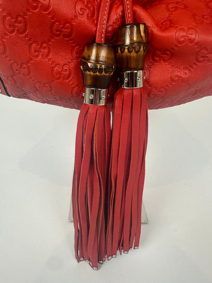 https://cdn.shopify.com/s/files/1/0900/2729/5066/files/Gucci_indy_bag_red_monogram_2007_Tassles.jpg?v=1776362149