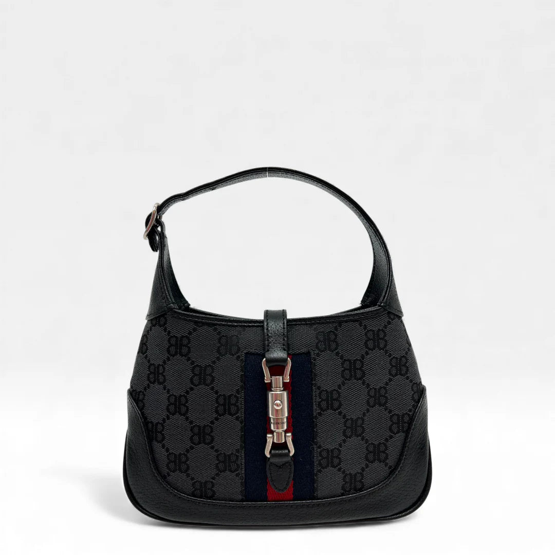 https://cdn.shopify.com/s/files/1/0564/9376/8855/files/Gucci_x_Balenciaga_Handtasche_Jackie_1961_mini_monogram_schwarz_vintage_GG_black_edition_handbag_9940.webp?v=1765456678