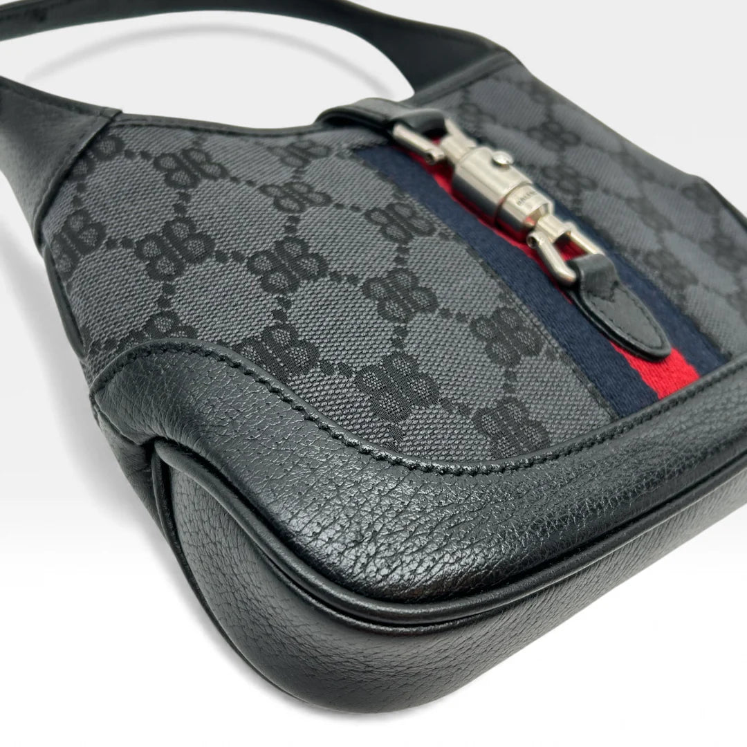 https://cdn.shopify.com/s/files/1/0564/9376/8855/files/Gucci_x_Balenciaga_Handtasche_Jackie_1961_mini_monogram_schwarz_vintage_GG_black_edition_handbag_9950.webp?v=1765456678