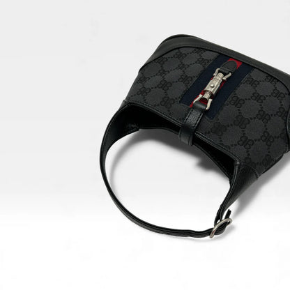 https://cdn.shopify.com/s/files/1/0564/9376/8855/files/Gucci_x_Balenciaga_Handtasche_Jackie_1961_mini_monogram_schwarz_vintage_GG_black_edition_handbag_9953.webp?v=1765456678