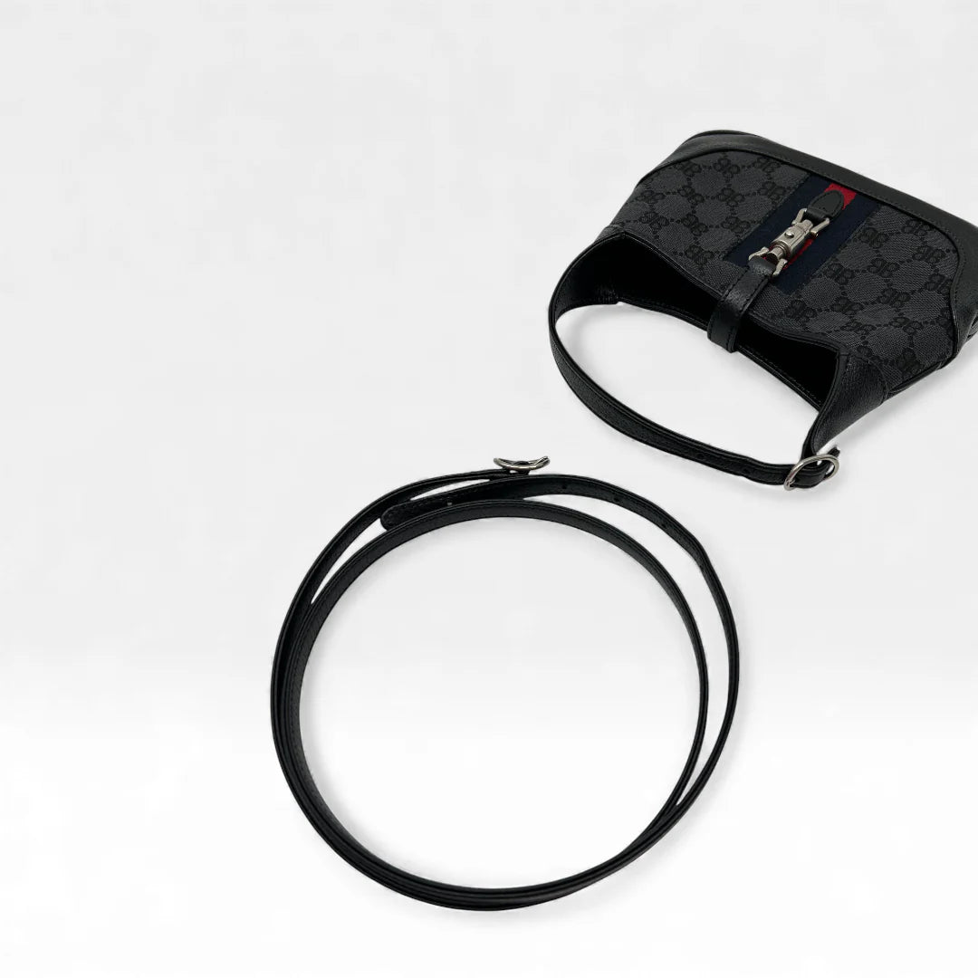 https://cdn.shopify.com/s/files/1/0564/9376/8855/files/Gucci_x_Balenciaga_Handtasche_Jackie_1961_mini_monogram_schwarz_vintage_GG_black_edition_handbag_9958.webp?v=1765456678