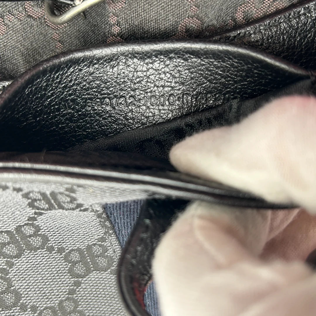 https://cdn.shopify.com/s/files/1/0564/9376/8855/files/Gucci_x_Balenciaga_Handtasche_Jackie_1961_mini_monogram_schwarz_vintage_GG_black_edition_handbag_9967.webp?v=1765456678