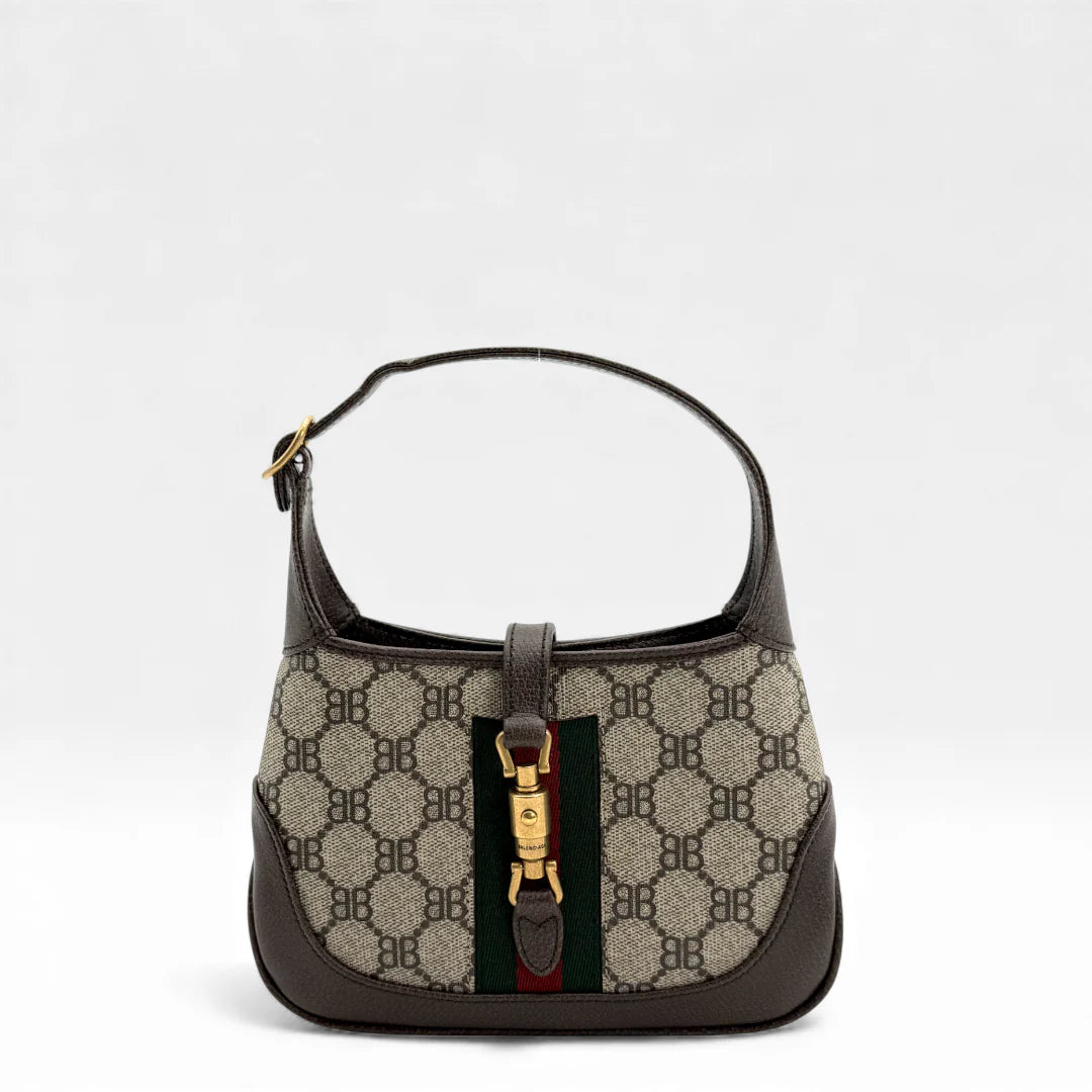 https://cdn.shopify.com/s/files/1/0564/9376/8855/files/Gucci_x_Balenciaga_Handtasche_Jackie_The_Hacker_small_monogram_beige___braun_vintage_GG_handbag_5143.webp?v=1765386135