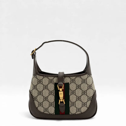 https://cdn.shopify.com/s/files/1/0564/9376/8855/files/Gucci_x_Balenciaga_Handtasche_Jackie_The_Hacker_small_monogram_beige___braun_vintage_GG_handbag_5143.webp?v=1765386135