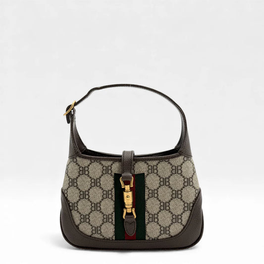 https://cdn.shopify.com/s/files/1/0564/9376/8855/files/Gucci_x_Balenciaga_Handtasche_Jackie_The_Hacker_small_monogram_beige___braun_vintage_GG_handbag_5143.webp?v=1765386135