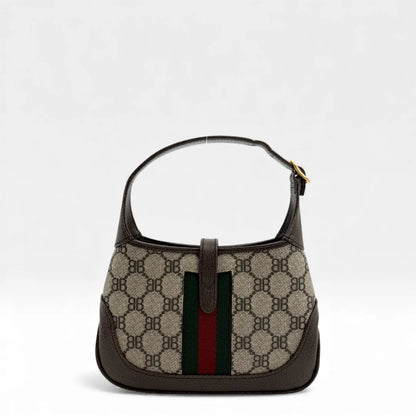 https://cdn.shopify.com/s/files/1/0564/9376/8855/files/Gucci_x_Balenciaga_Handtasche_Jackie_The_Hacker_small_monogram_beige___braun_vintage_GG_handbag_5144.webp?v=1765386248