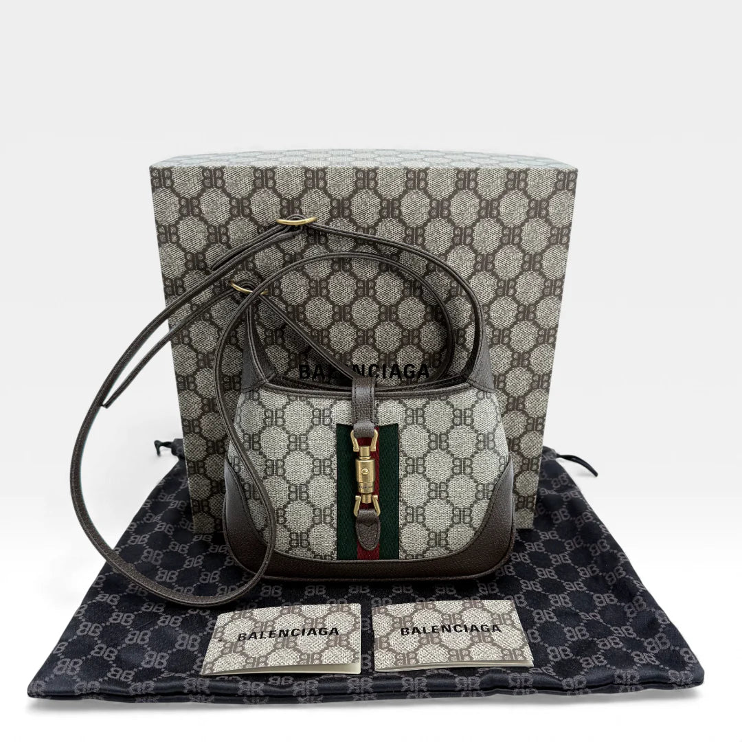 https://cdn.shopify.com/s/files/1/0564/9376/8855/files/Gucci_x_Balenciaga_Handtasche_Jackie_The_Hacker_small_monogram_beige___braun_vintage_GG_handbag_5161.webp?v=1765386248