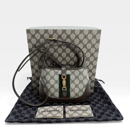 https://cdn.shopify.com/s/files/1/0564/9376/8855/files/Gucci_x_Balenciaga_Handtasche_Jackie_The_Hacker_small_monogram_beige___braun_vintage_GG_handbag_5161.webp?v=1765386248