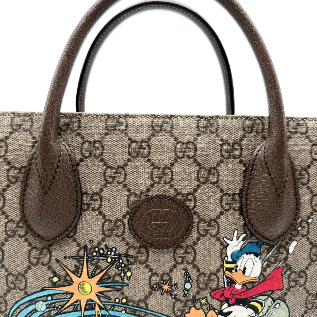 https://cdn.shopify.com/s/files/1/0564/9376/8855/files/Gucci_x_Disney_Handtasche___Tote_Bag_Donald_Duck_Ebony_GG_Supreme_monogram_beige___braun4317.webp?v=1764850487