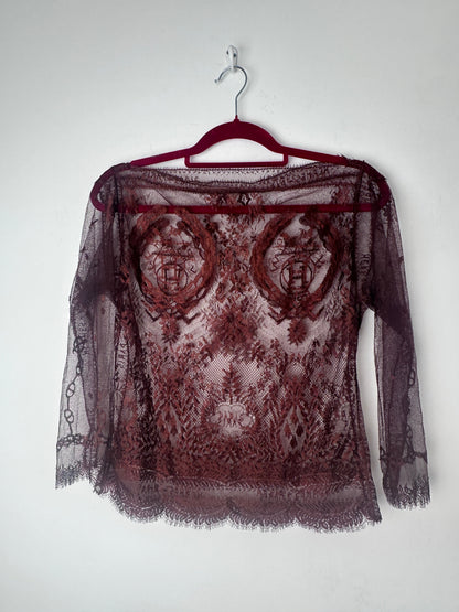 Intricate red lace top on a red hanger