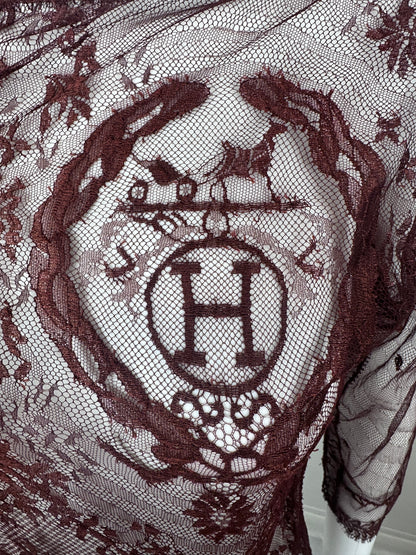 Close up of Hermes logo in burgundy lace