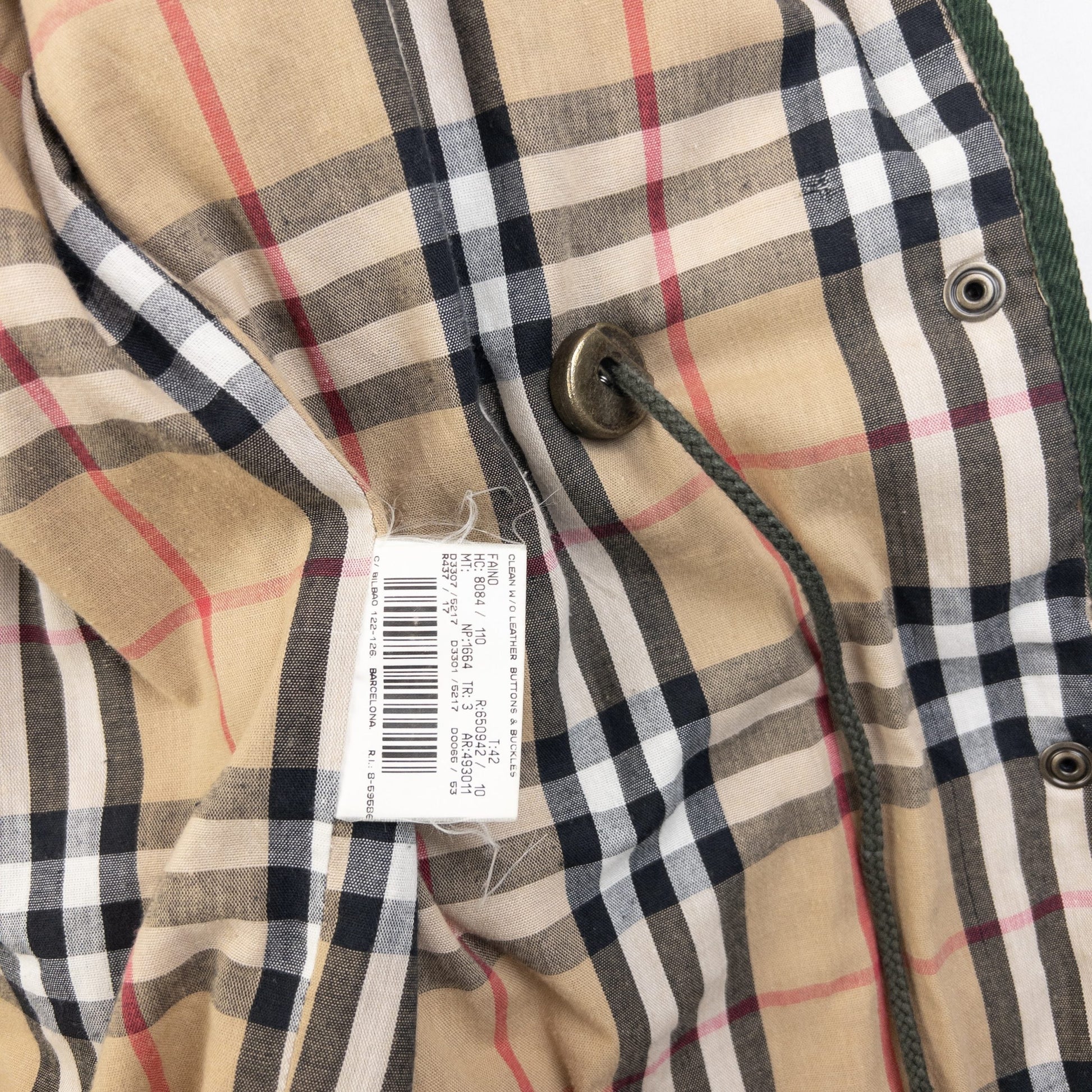 Burberry green quilted jacket with Nova Check lining, snap button closure, and corduroy collar.