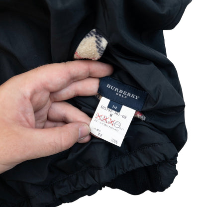 Burberry beige and black reversible jacket featuring classic Nova Check pattern and branded zipper pull.