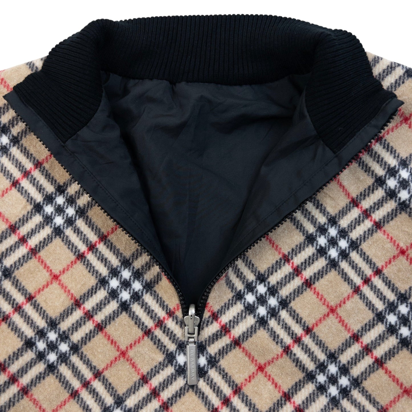 Burberry beige and black reversible jacket featuring classic Nova Check pattern and branded zipper pull.