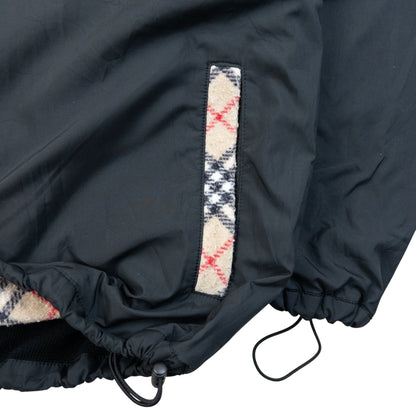 Burberry beige and black reversible jacket featuring classic Nova Check pattern and branded zipper pull.