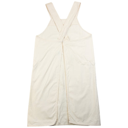 ISSEY MIYAKE beige apron with crossed back straps and stamped logo pocket detail