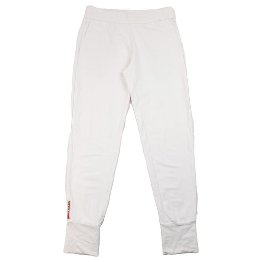 Prada white joggers with subtle signature patch on lower leg and ribbed cuffs.