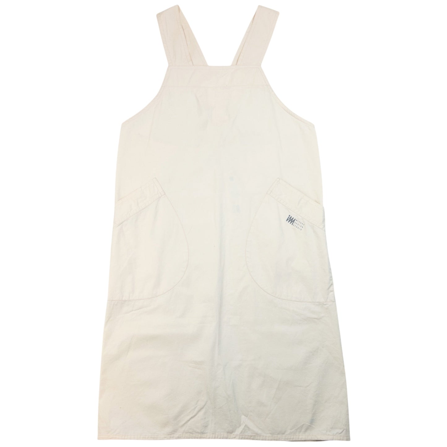 ISSEY MIYAKE beige apron with crossed back straps and stamped logo pocket detail
