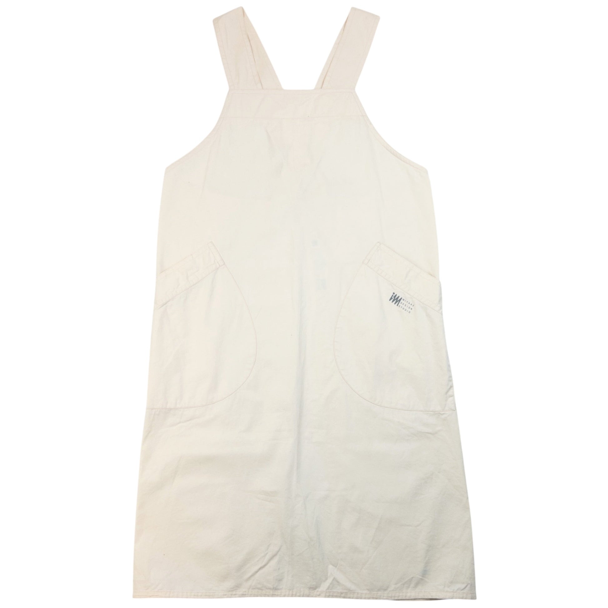 ISSEY MIYAKE beige apron with crossed back straps and stamped logo pocket detail