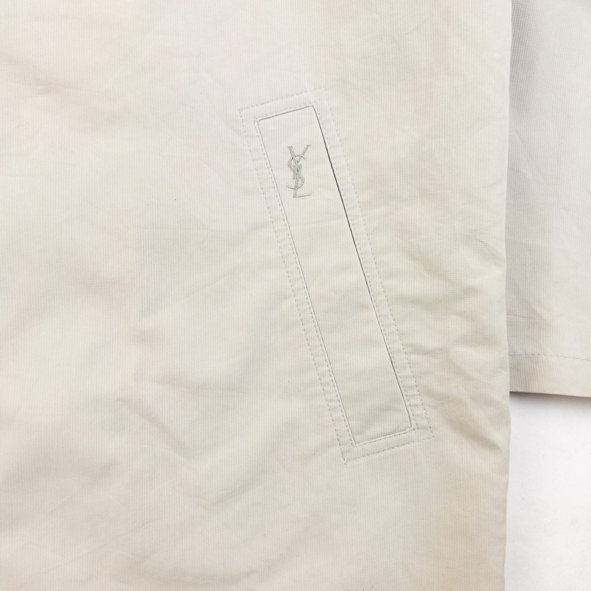 YVES SAINT LAURENT beige Harrington jacket with YSL embroidery on pocket and checkered lining.