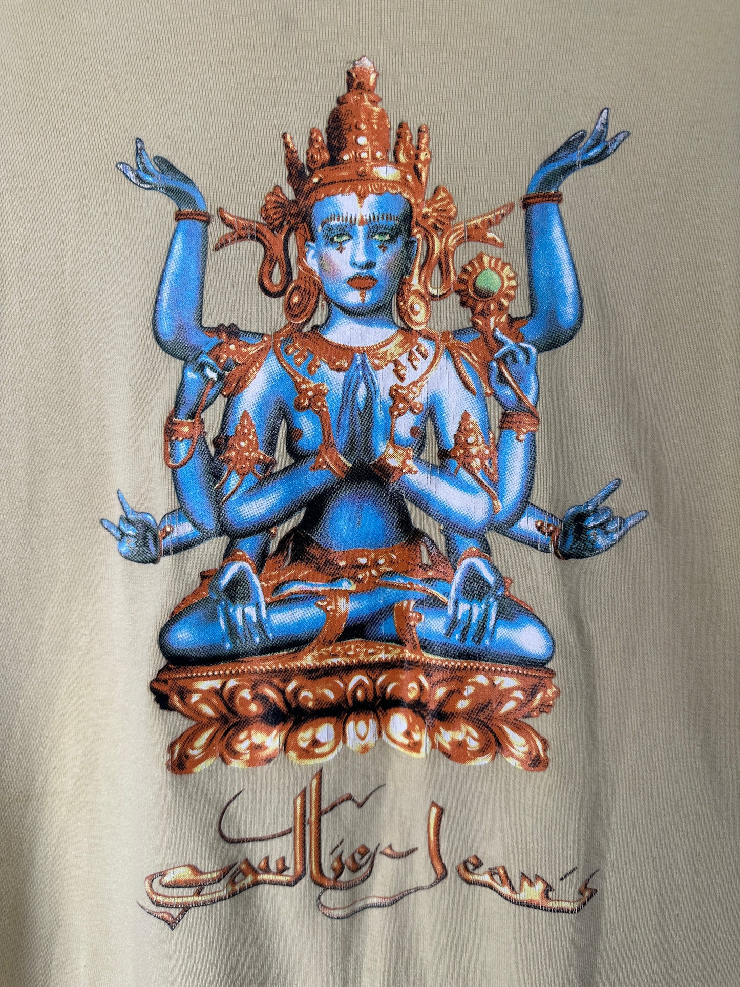 Decorative figurine of a blue and gold deity on a beige background