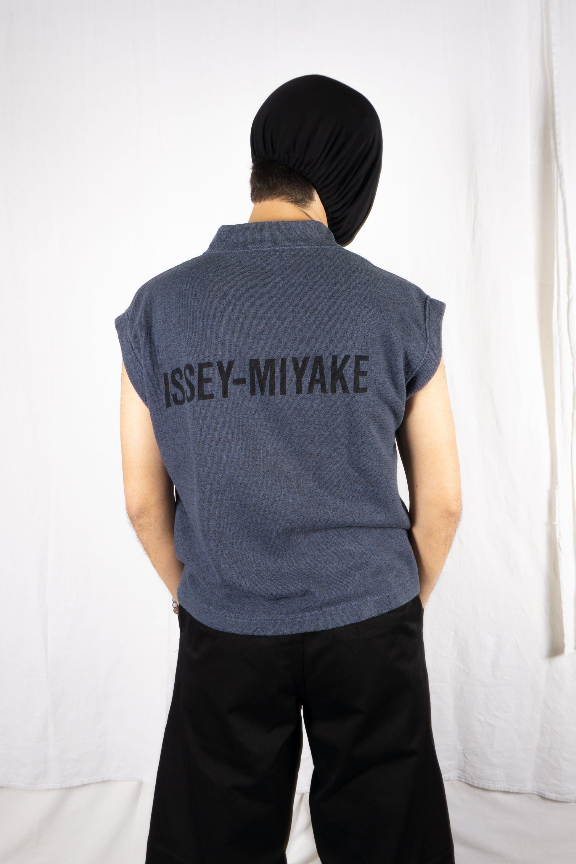 https://cdn.shopify.com/s/files/1/0821/7405/0644/files/Issey_Miyake_Men_80_s_Logo_Vest_Recente_Studio.jpg?v=1752574305