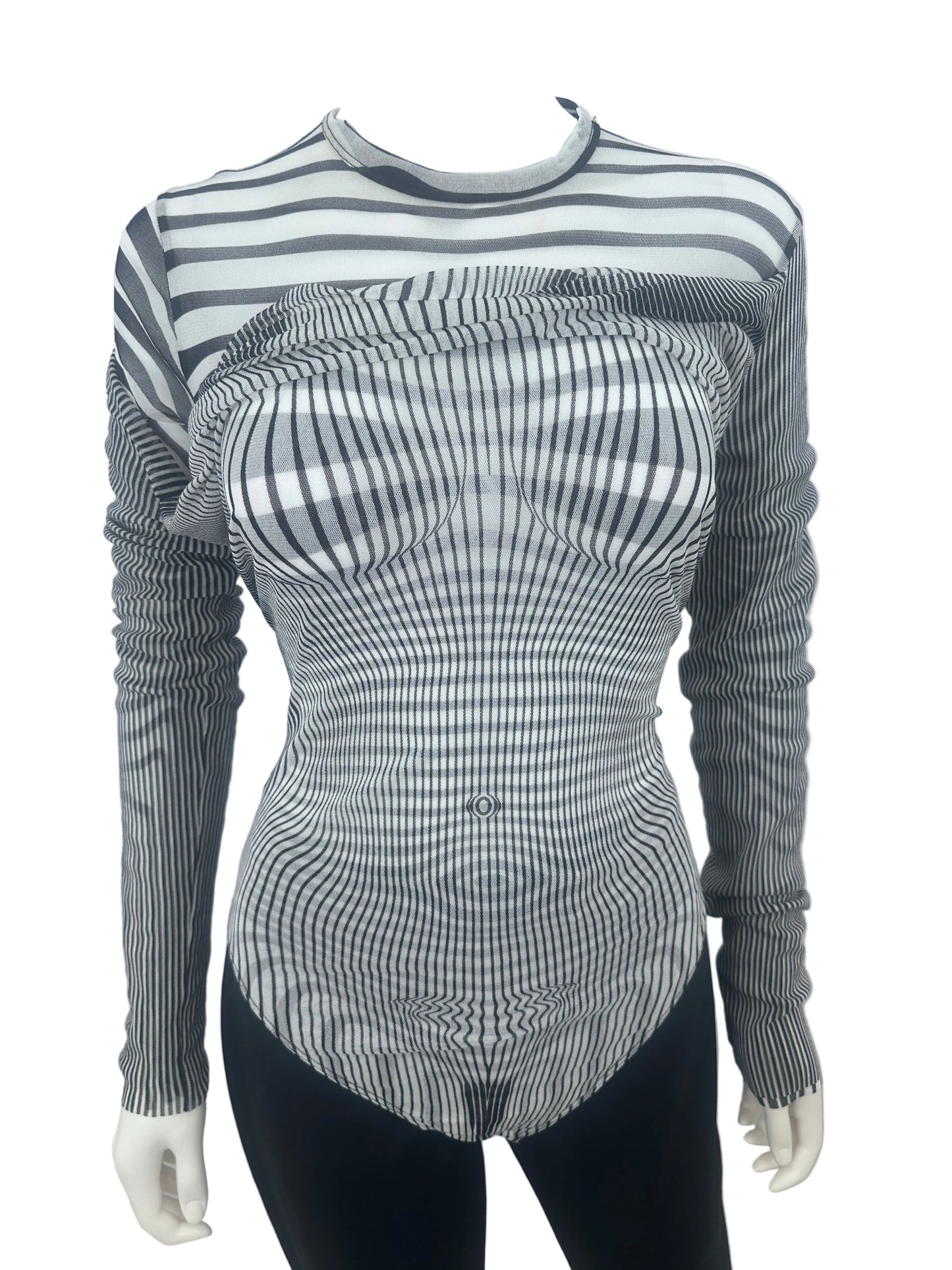 A long-sleeve ribbed knit top with a black and white wavy stripe pattern, displayed on a mannequin torso against a plain white wall.
