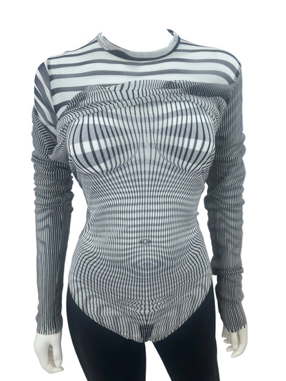 A long-sleeve ribbed knit top with a black and white wavy stripe pattern, displayed on a mannequin torso against a plain white wall.