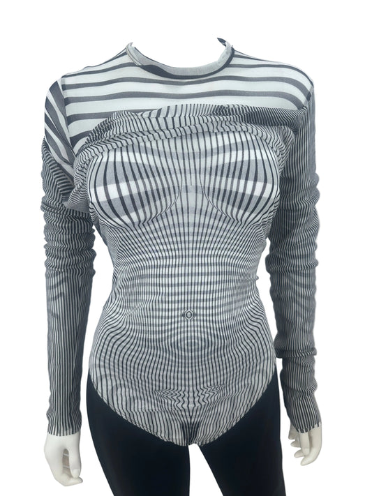 A long-sleeve ribbed knit top with a black and white wavy stripe pattern, displayed on a mannequin torso against a plain white wall.