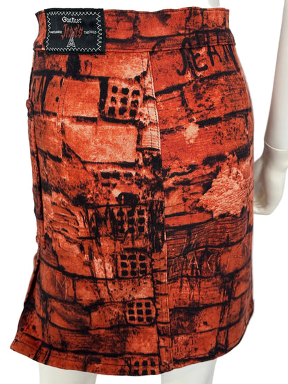 https://cdn.shopify.com/s/files/1/0900/2729/5066/files/Jean_Paul_Gaultier_FW_1997_Fight_Racism_Skirt_BAck.jpg?v=1774458343