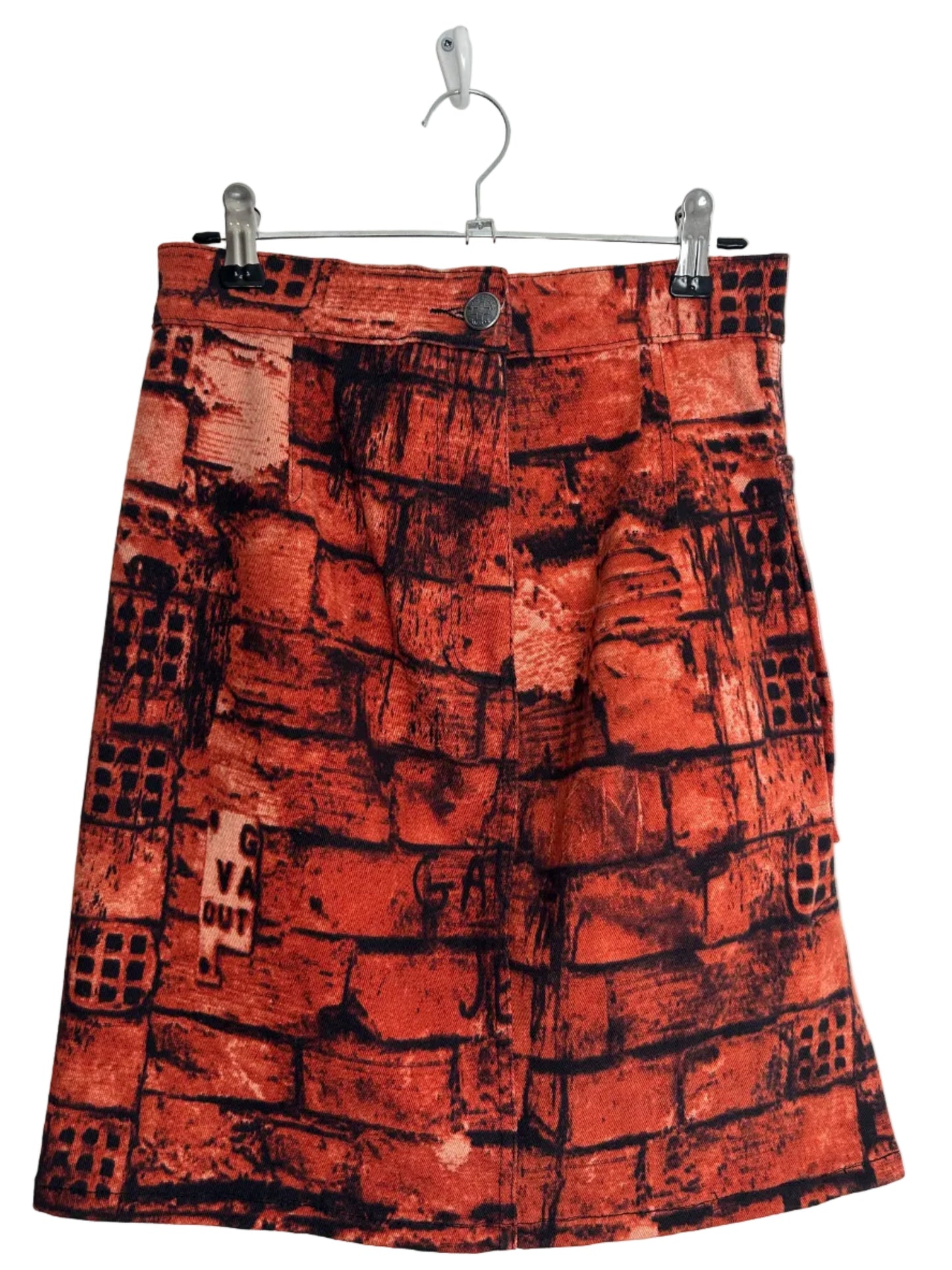 https://cdn.shopify.com/s/files/1/0900/2729/5066/files/Jean_Paul_Gaultier_FW_1997_Fight_Racism_Skirt_hanger.jpg?v=1774458413