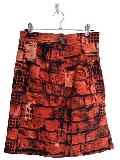 https://cdn.shopify.com/s/files/1/0900/2729/5066/files/Jean_Paul_Gaultier_FW_1997_Fight_Racism_Skirt_hanger.jpg?v=1774458413