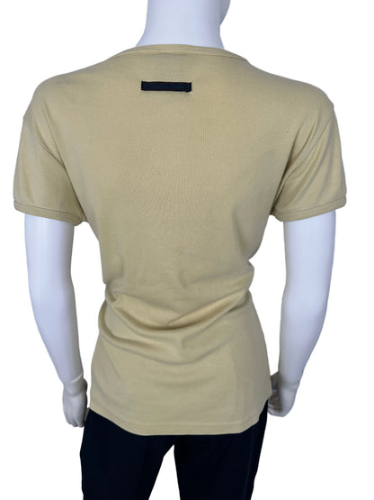 Beige top on a mannequin against a white background