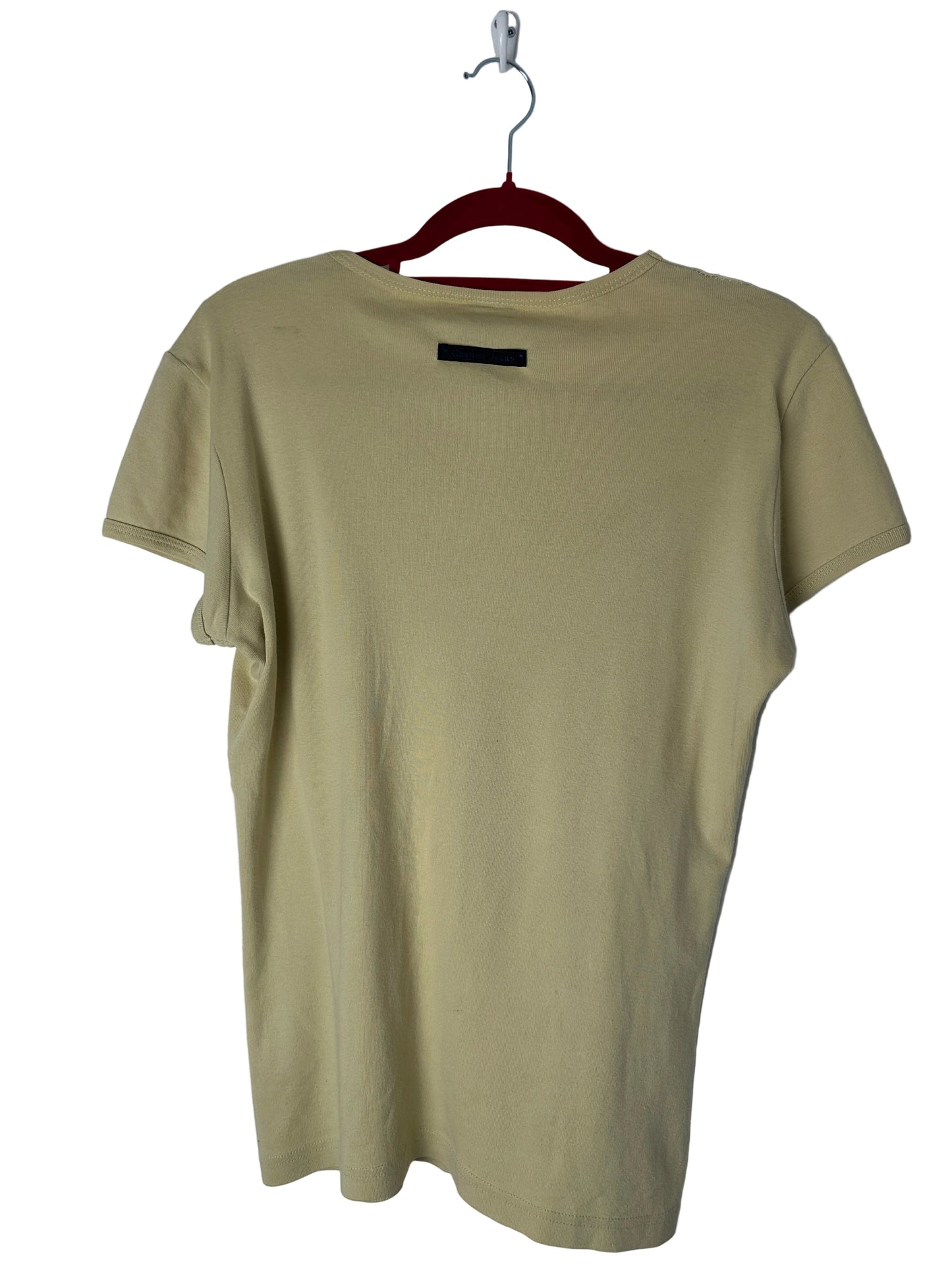 Beige t-shirt on a hanger against a white background