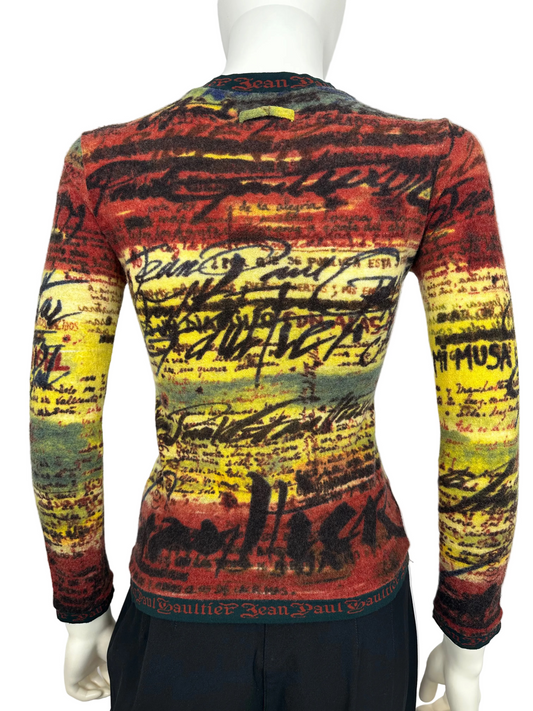 Colorful patterned sweater on a mannequin against a white background