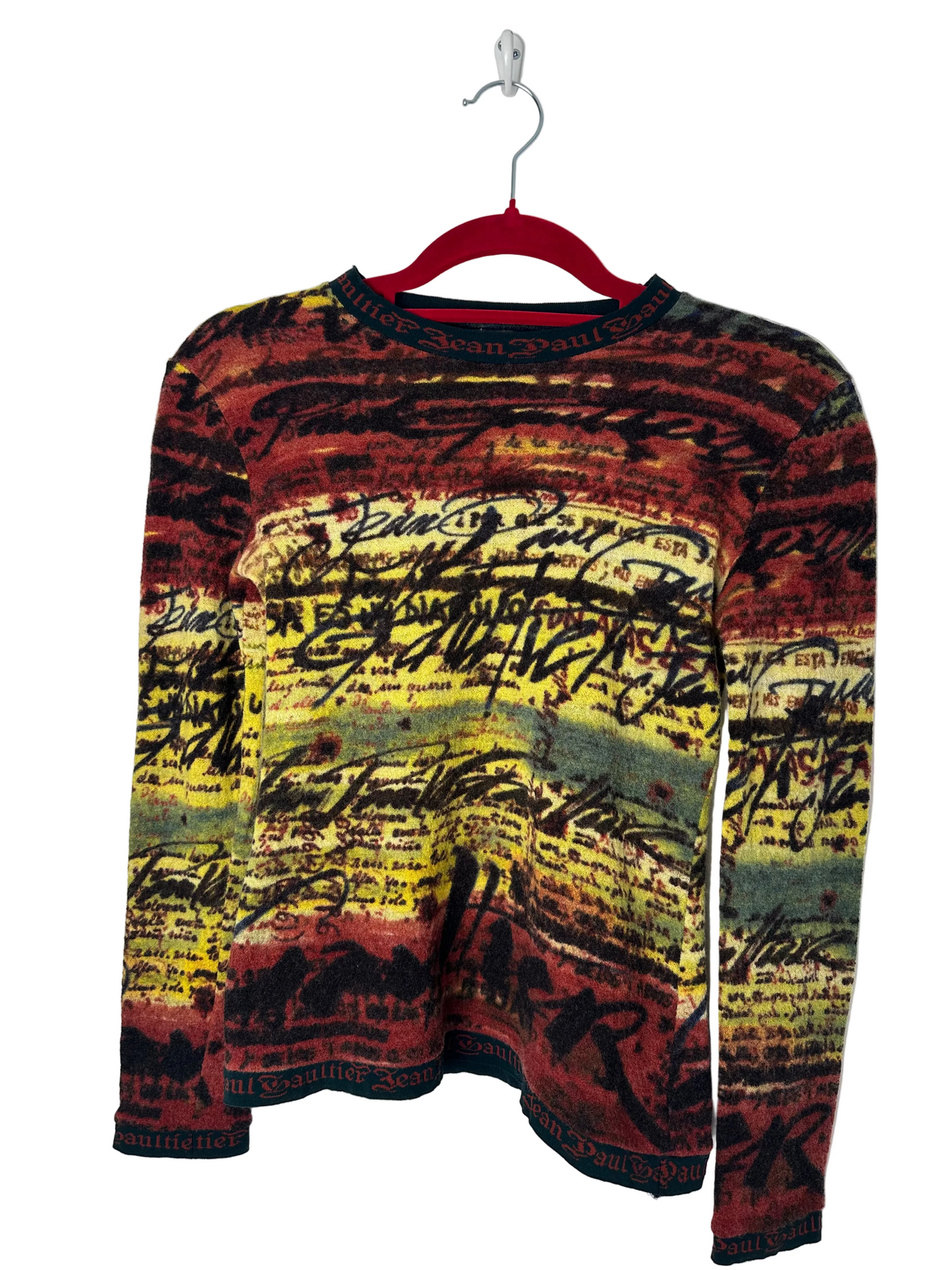 https://cdn.shopify.com/s/files/1/0900/2729/5066/files/Jean_Paul_Gaultier_Knit_Script_Top_Hanger.heic?v=1768420431