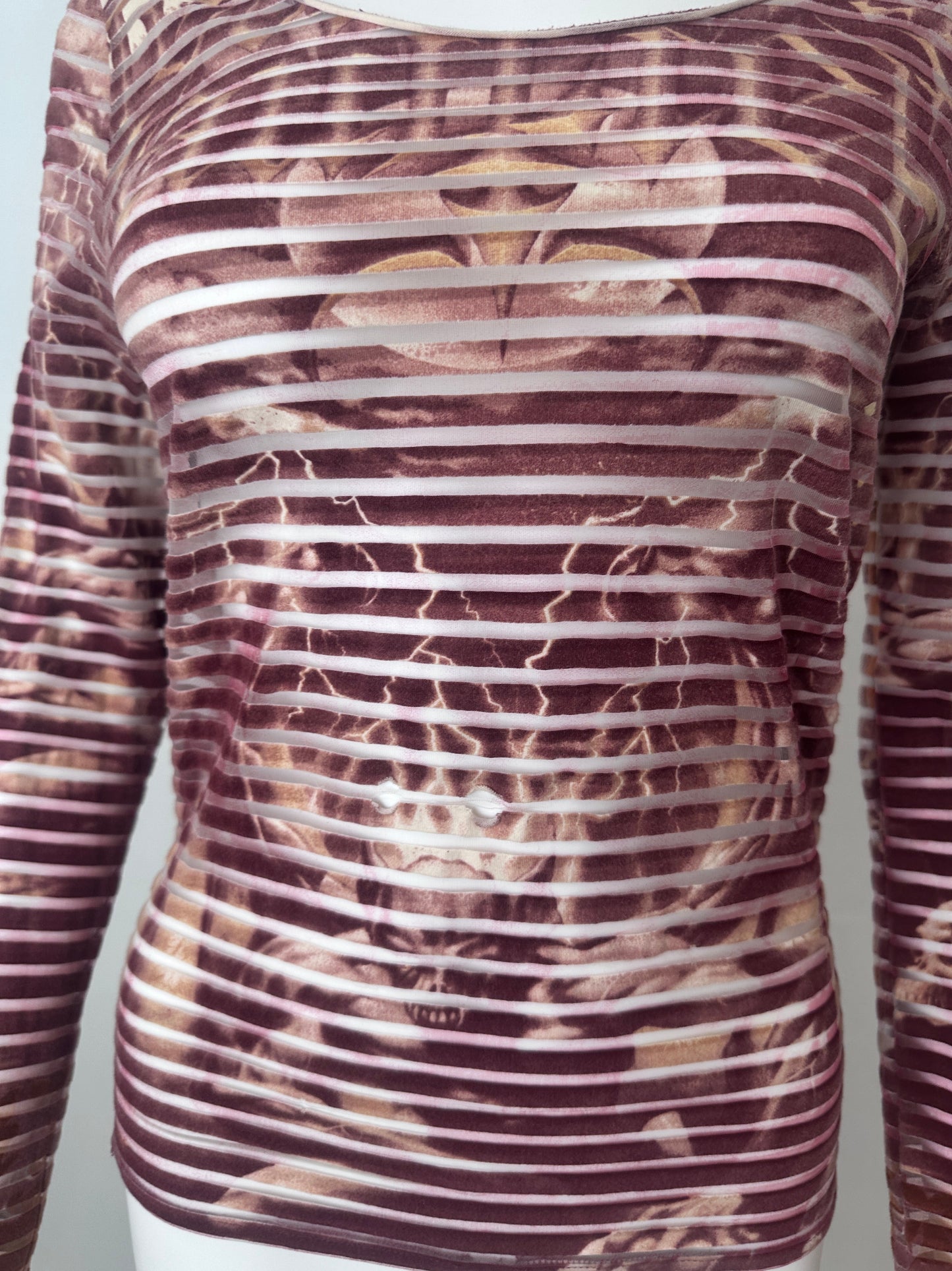 Close up of a red striped top with demon print