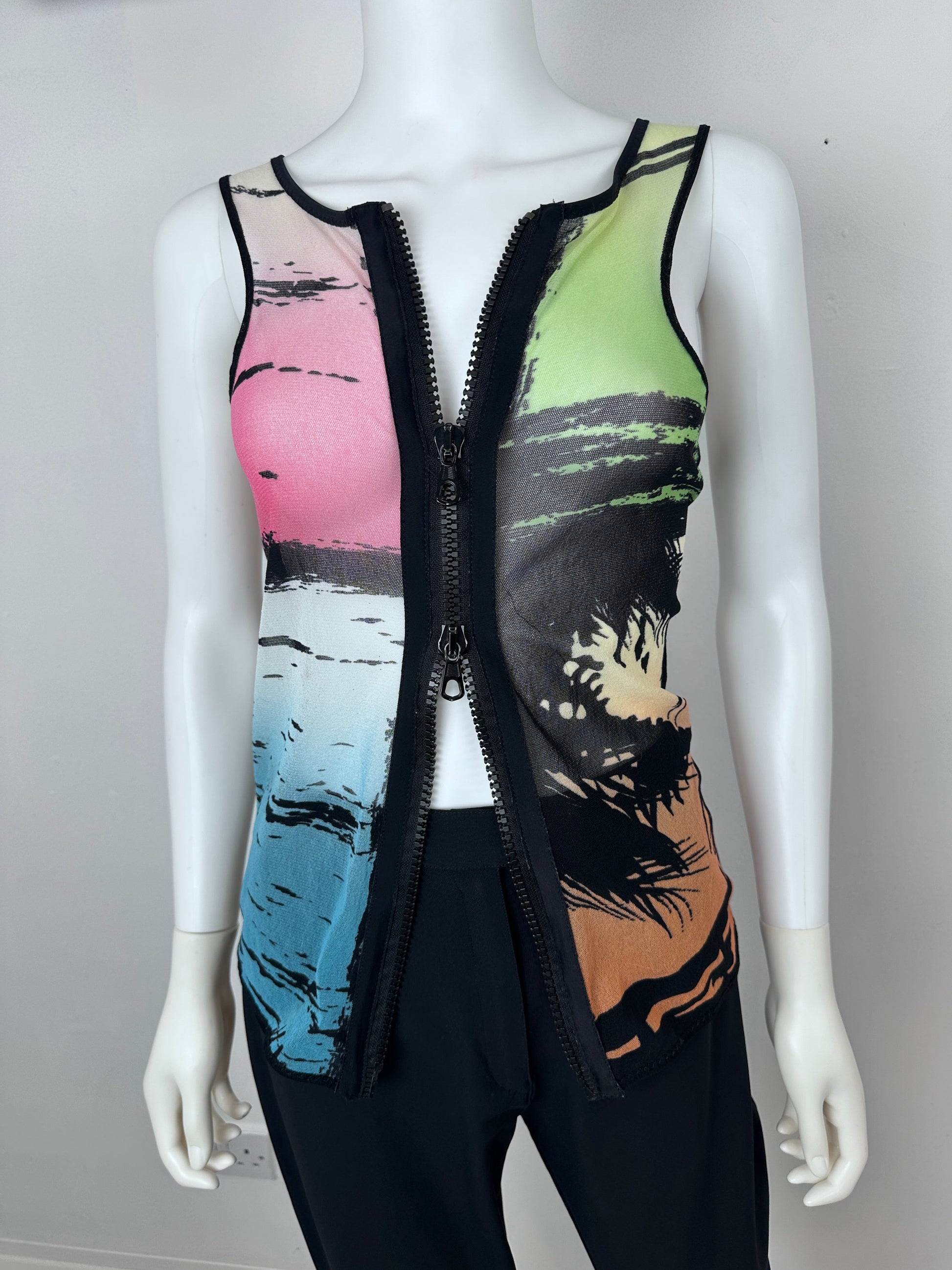A sleeveless black zip-up vest with a colorful abstract print on the front, displayed on a white mannequin torso against a light gray background.