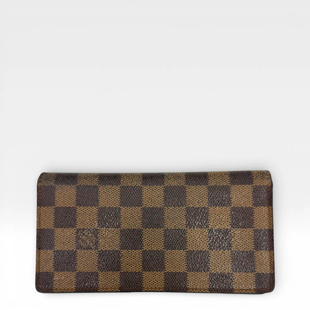 https://cdn.shopify.com/s/files/1/0564/9376/8855/files/Louis_Vuitton_Geldbeutel_Portefeuille_Damier_Ebene_braun_vintage_LV_8670.webp?v=1769075831